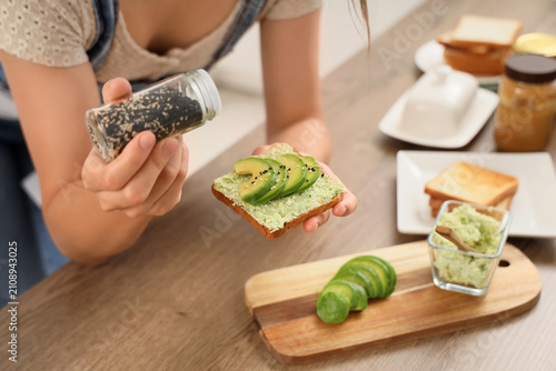 Person sprinkling sesame se...