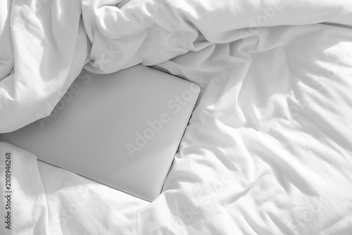 Laptop on white blanket, to...