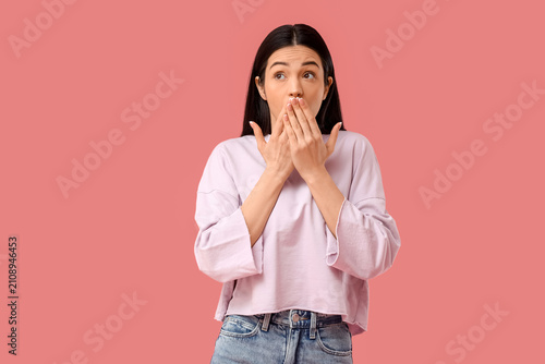 Shocked young woman coverin...