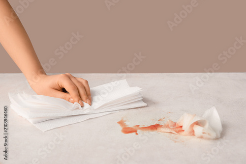Woman wiping ketchup with p...