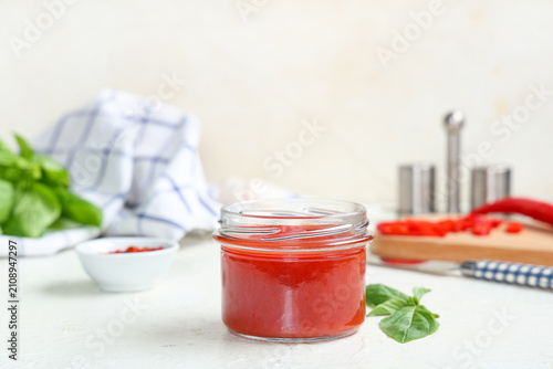 Jar of tomato sauce with ba...