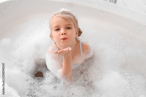 Cute little girl with foam ...