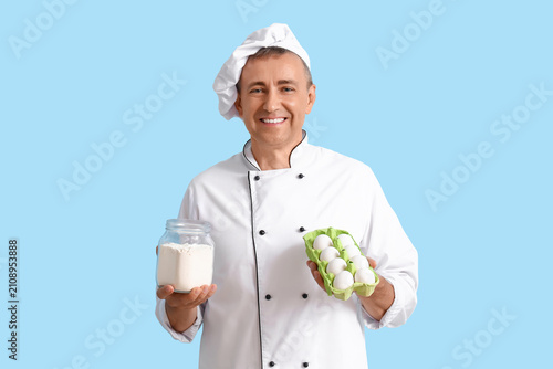 Mature chef with flour and ...