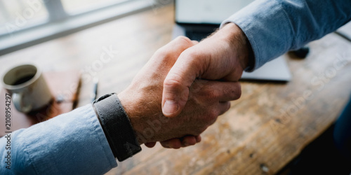 Close up of a professional handshake in an office