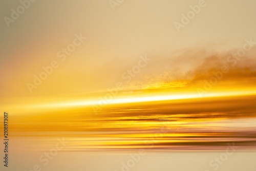 Abstract golden sunset horizon with motion blur and light streaks