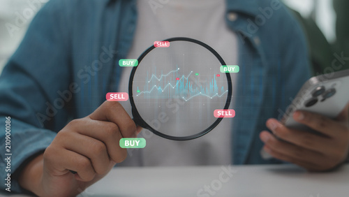 Person holding magnifying glass analyzing glowing stock chart with buy and sell tags. Concept of stock market investment, crypto trading, technical data analysis and finance strategy.