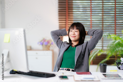 Quadro su tela Successful young businesswoman relaxing at home office, completing work, feeling