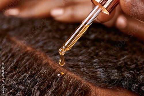 Close-up of Hair Growth Serum Dropping onto Scalp for Hair Care.