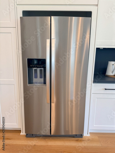 View of a modern brushed stainless steel side-by-side refrigerator.