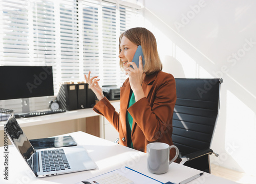 Woman smiling to herself as she works in an office