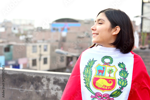 Teenager girl wrapped in peruvian flag.