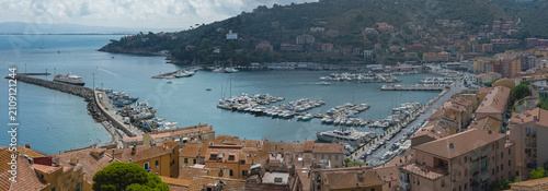 Aerial View of Porto Santo Stefano Harbor with Boats and Coastal Village in Tuscany, Italy