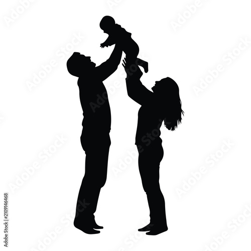 Silhouette of parents playing with baby, holding up infant