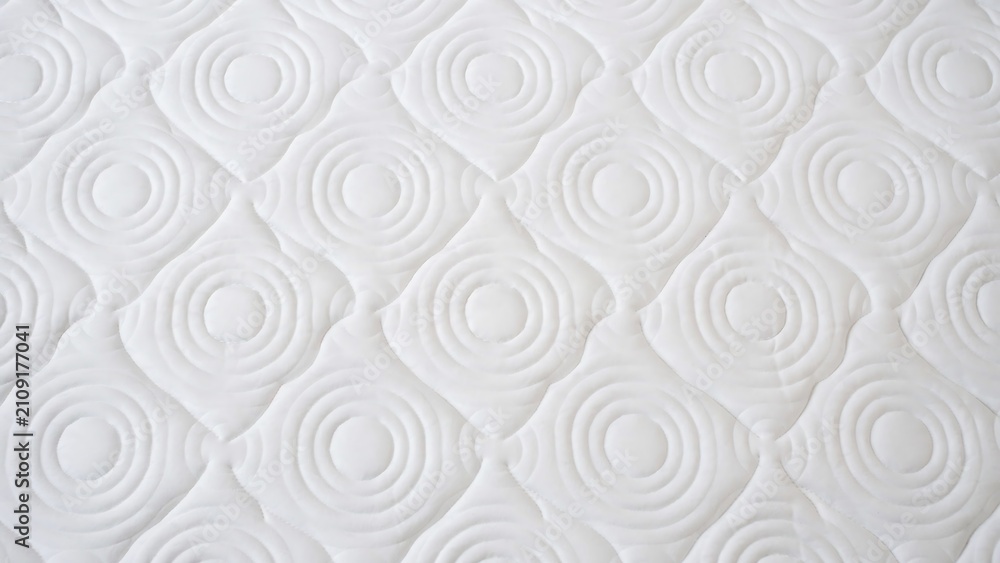 Obraz premium Clean white quilted mattress protector fabric texture background with mattress