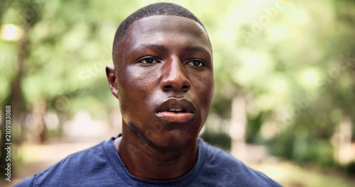 Man, sweating and fatigue at park, fitness and breathing after physical activity and tired on break. Exhausted, black person and workout recovery in nature, thinking runner and wellness on weekend
