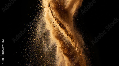 Billowing desert dust storm plume isolated against black background