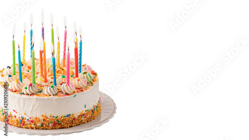 Large round birthday cake decorated with colorful burning candles isolated on transparent background cut out