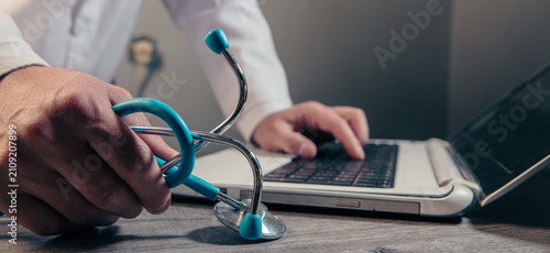 Doctor using a stethoscope to measure blood pressure. Healthcare and medical concept.