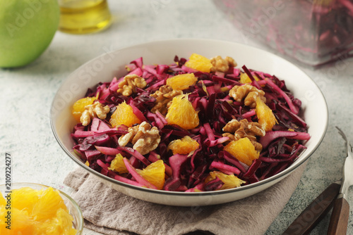 Bild auf Leinwand Red cabbage salad with oranges and walnuts - a traditional dish of Norwegian cui