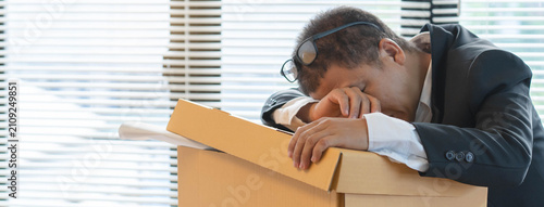 Fotografie Stressed businessman quitting career job due to employee layoff because covid19 corona virus disease effect