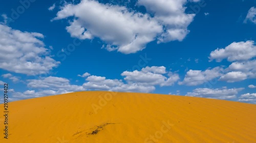 sandy dune under a cloudy sky time lapse scene