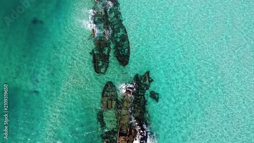 Aerial view of rusted shipwrecks in turquoise sea at Tangalooma