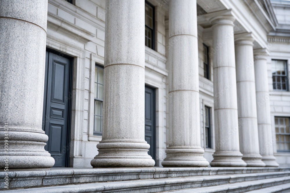 Fototapeta premium Grand Classical Architecture: Majestic Stone Columns of a Government Building or Courthouse Entrance