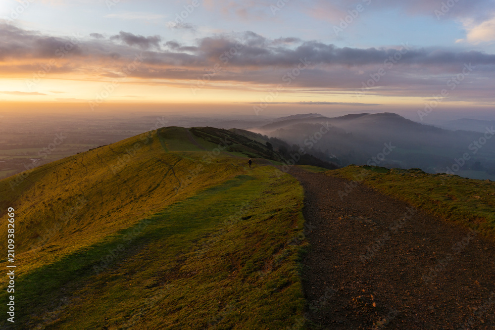 Fototapeta premium Misty, early morning sunrise over the Malvern Hills in December, Worcestershire, England