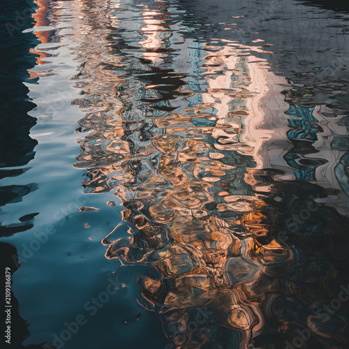 Abstract Water Reflection with Colorful Ripples and Urban Light Reflections