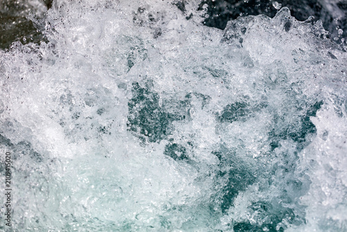 Quadro em tela White foam crashes against dark, churning water