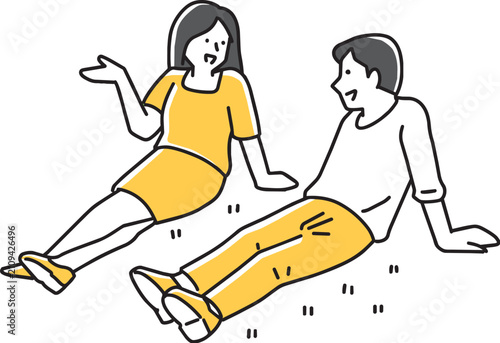草むらでリラックスながら会話する男女