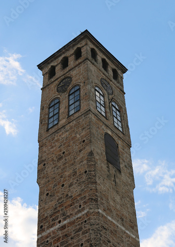 Ottoman era Clock Tower  with blue sky background in Sarajevo, Bosnia and Herzegovina