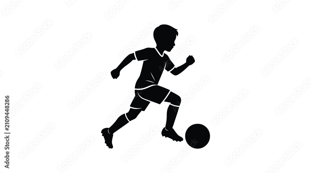 Fototapeta premium Silhouette of a young boy sprinting across the field while dribbling a black soccer ball