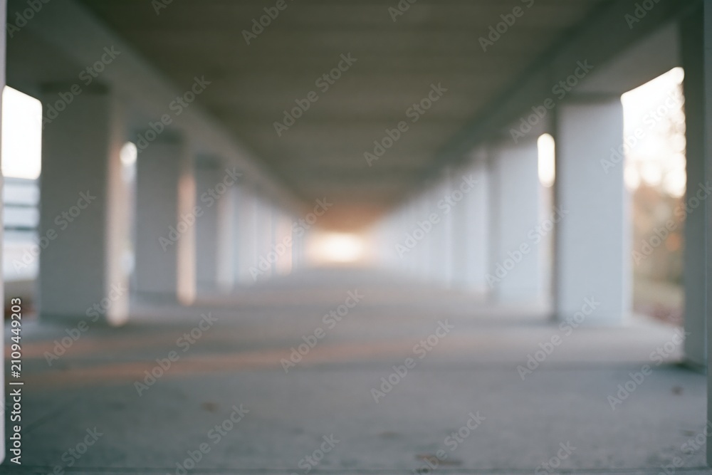 Fototapeta premium The Underpass Corridor of Columns with Vanishing Perspective at Dusk