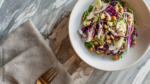 A modern flat lay of miso crunch salad styled asymmetrically on a marble surface with refined editorial composition and subtle reflections