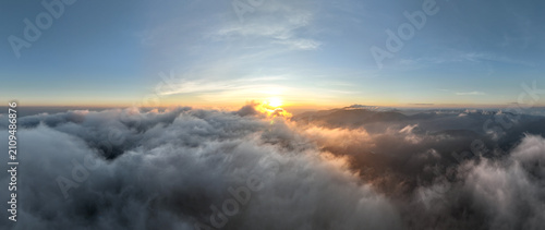 Golden Sun Illuminates A Dense Sea Of Clouds Rolling Over Mountain Peaks During Sunrise In Chiang Mai Thailand To Showcase Breathtaking Natural Beauty