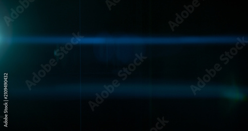 Obraz na plátně Abstract cinematic anamorphic lens flare overlay with blue horizontal light streaks and warm orange glow on a black background