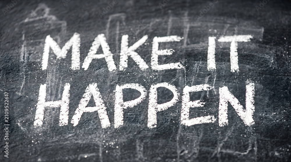 Fototapeta premium Handwritten chalk motivational quote on blackboard. Inspirational make it happen lettering for success and goal achievement.