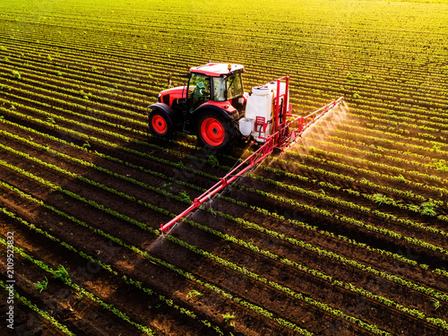 Tractor spraying soybean field aerial view agriculture