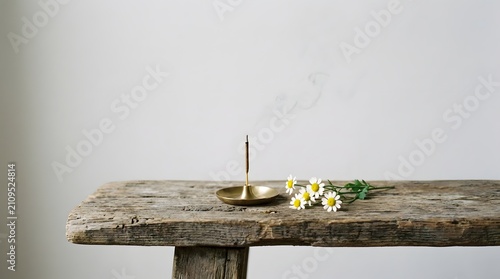 Zen Candle with Daisies on Rustic Wooden Table for Meditation and Calmness