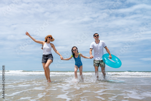 Bild auf Leinwand A cheerful family splashes through shallow seawater embracing outdoor fun health