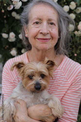 A cute senior woman and her lap dog