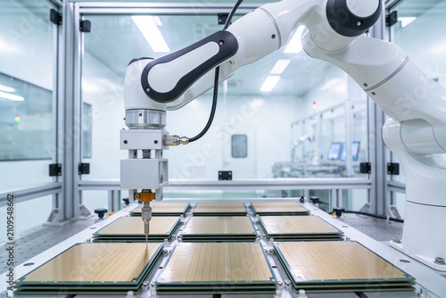 Foto Automated robotic arm precisely placing components on circuit boards in a cleanr