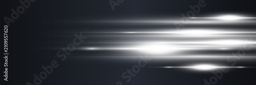 Bright light streaks moving horizontally across a dark abstract background with lens flares, symbolizing speed