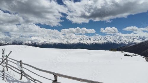 Snowy Koruldi ridge landscape in Svaneti Georgia with wooden fence and majestic Caucasus mountains, winter travel destination