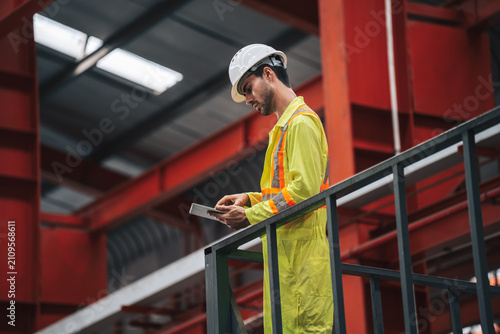 фотографія Technician in Safety Gear Working in Modern Industrial Factory Setting