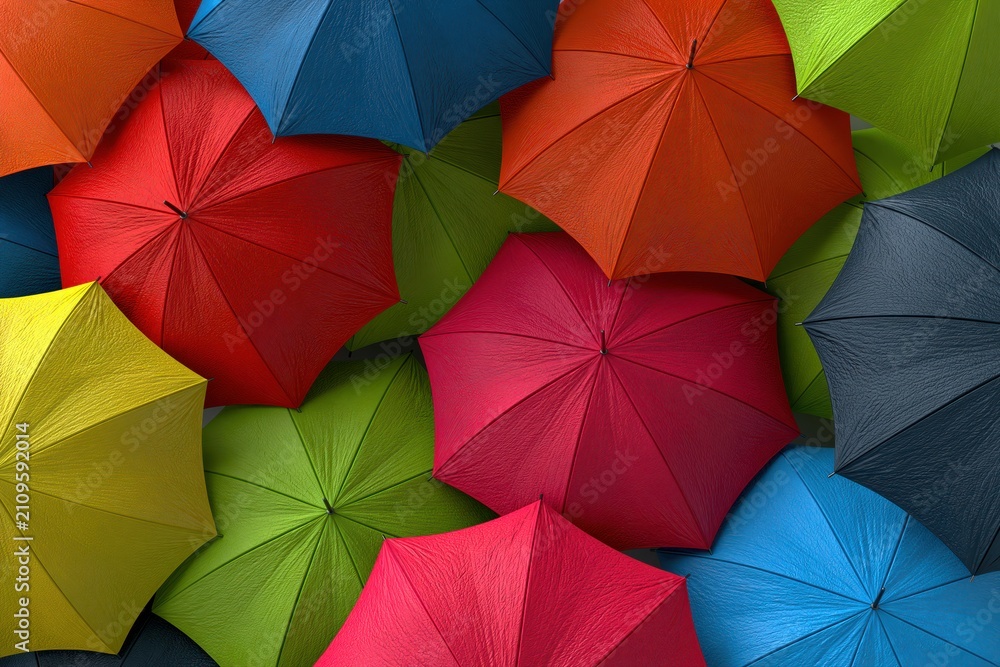 Obraz premium A vibrant and colorful overhead view of many open umbrellas in various bright hues.