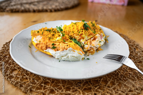 Salty omelette filled with fresh cheese and ham. Sprinkled with grated cheese and herb.