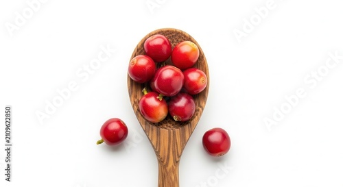 red cranberries on wooden spoon