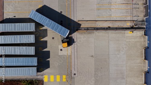 Top down aerial view of heavy goods vehicles and logistics operation at distribution warehouse